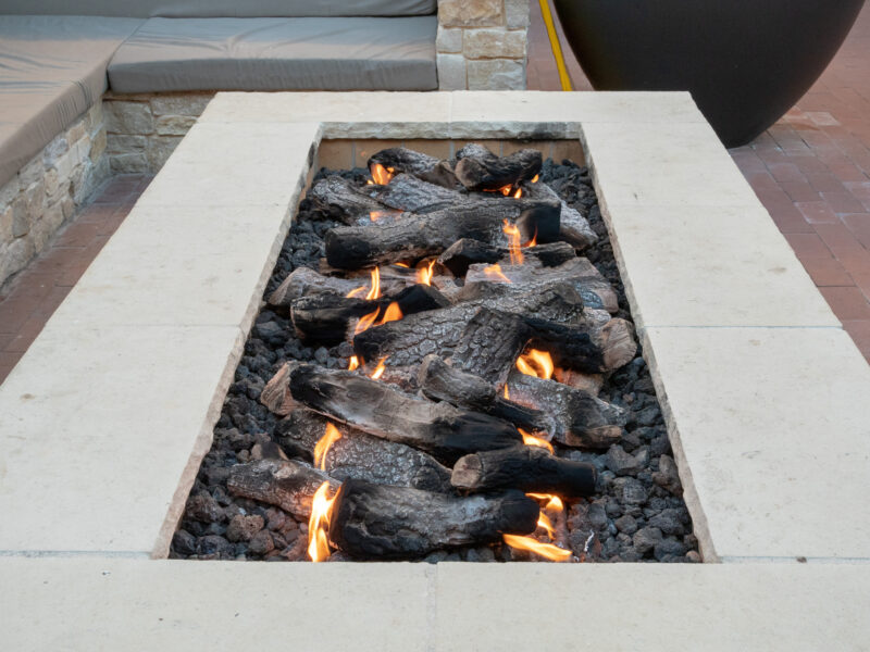 Long, rectangular fire pit sitting in open air plaza